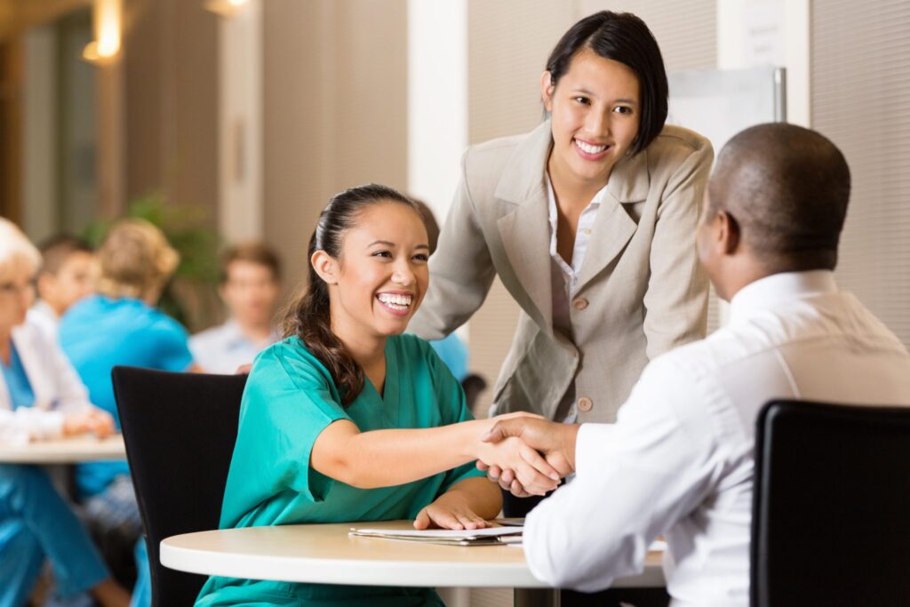 Hospitality team members shaking hands during a meeting