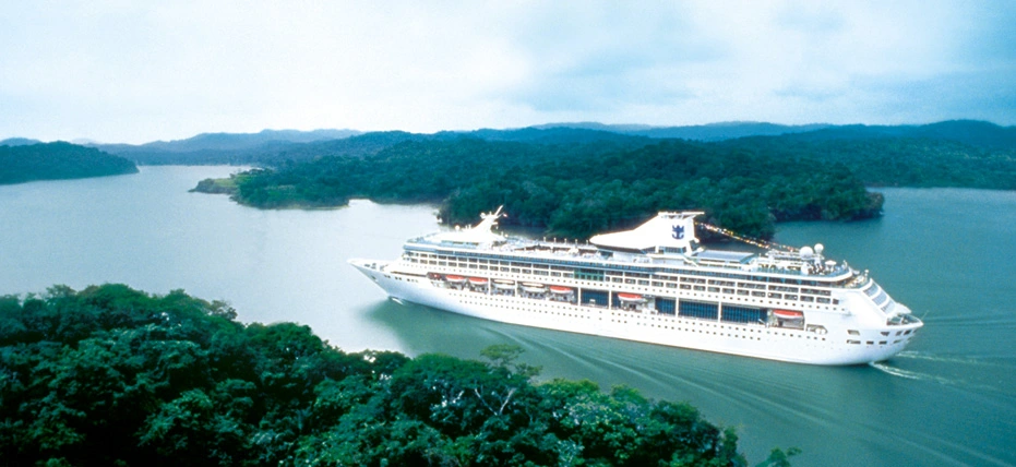 Cruise ship crossing a lake surrounded by tropical forest in Panama