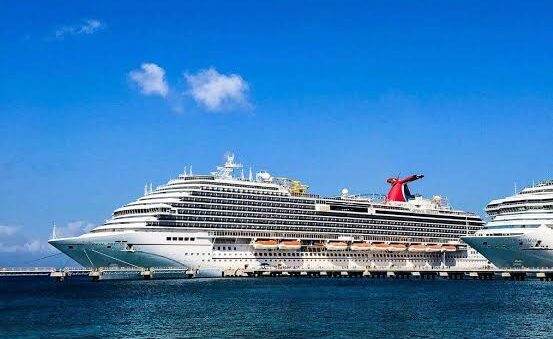 Carnival cruise ship docked in clear blue Caribbean water