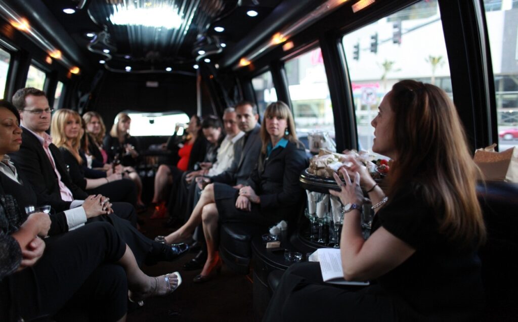Business guests riding together inside a party bus